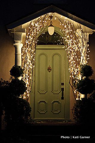 Using branches w/ lights by the front door for Christmas time – beautiful!