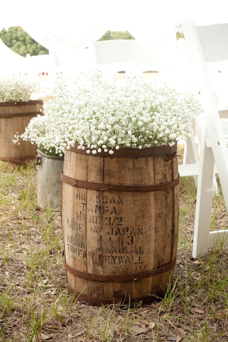 Whiskey barrel & baby's breath to go in front of the arch or in front of