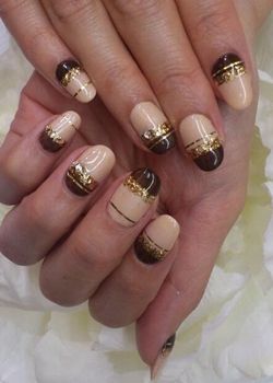 brown and beige stripes with gold glitter new years eve nail art