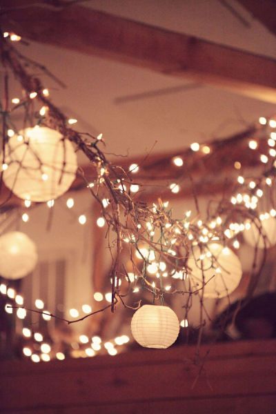 love the combination of lanterns, twigs and twinkle lights!
