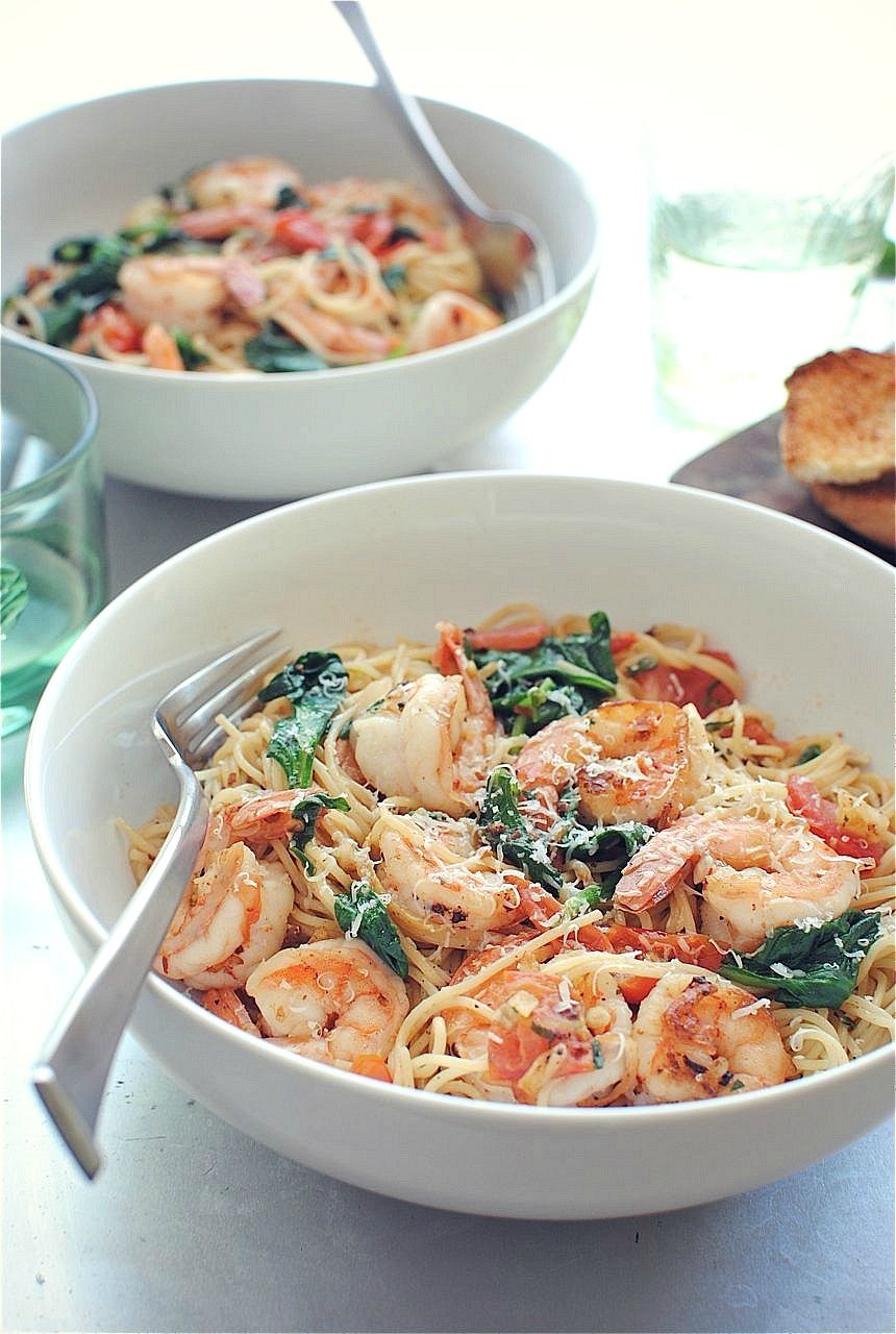 shrimp pasta with tomatoes, lemon, and spinach