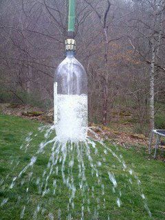 Take a 2 liter soda bottle, poke holes in it. Attach to a garden hose. Toss over