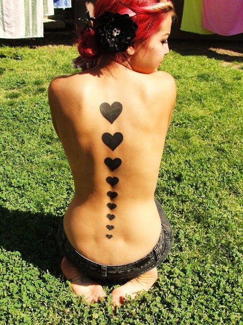Ah! I really want a spine tattoo. Love this one.    The girl has 9 hearts going