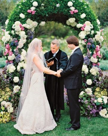 Dutch hydrangeas, and heirloom garden roses adorned this ceremony arch