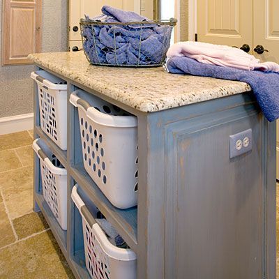 Laundry room island.  A place to fold on top, baskets to put folded laundry in (