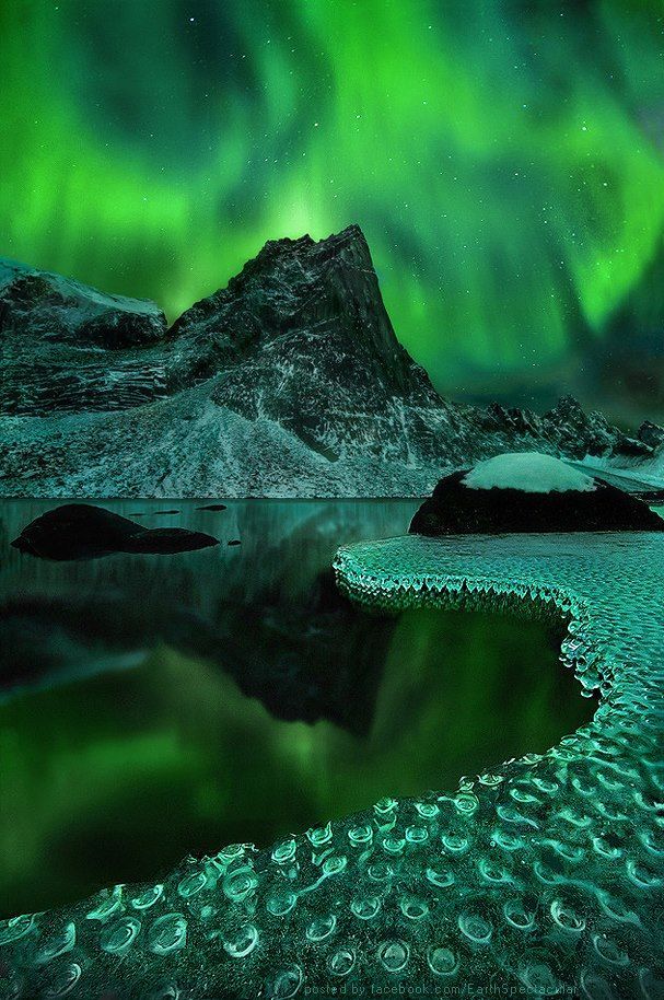 Magical view of Aurora Borealis reflected on frozen icicles