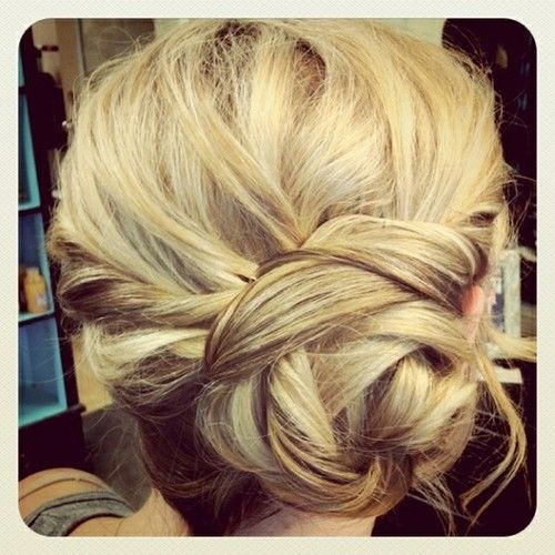 One side braid twist into a bun. Use bobby pins to shape and secure.