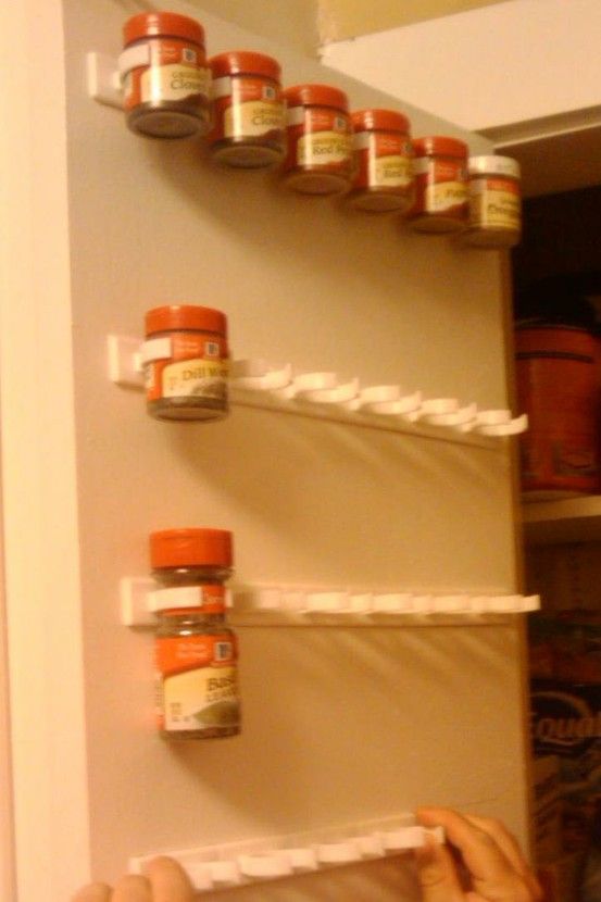 Use a mop holder to store spices on the inside of a cabinet door.