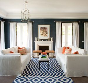 navy blue walls, white and coral living room