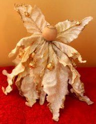 A Poinsettia Angel – Use a wired silk flower, a wooden ball for a head, a hot gl