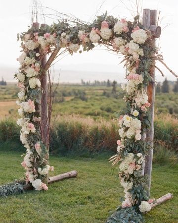 A floral arch anchored this outdoor ceremony–click to see more from this Wyomin