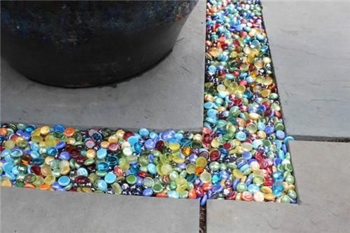 Colored glass Instead of gravel in the garden or patio…you can get these at th