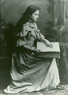 Helen Keller reading braille