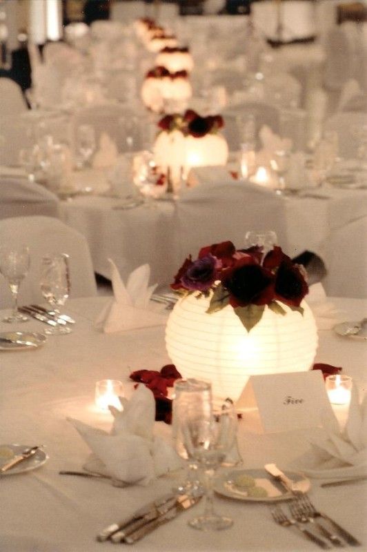 Paper lanterns as light-up centerpieces – nice idea.  Place lantern over a clear