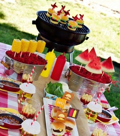 Backyard BBQ table – love the corn and watermelon on skewers in metal bins, and