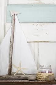 Beach or summer decor- driftwood sailboat, starfish, votive wrapped in rope, peb