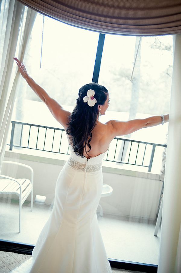 Beautiful wedding hairstyle half up do with flower accent, photo by Adam Nyholt