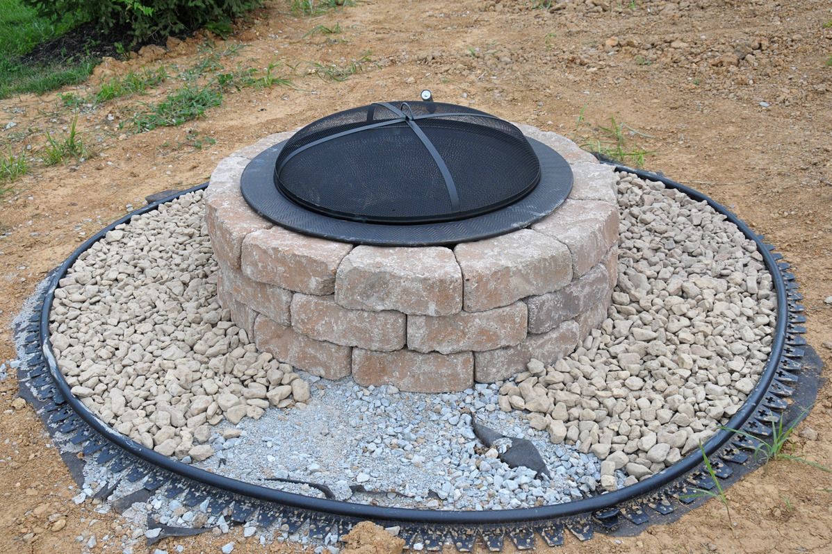 DIY fire pit. I like the idea of the gravel surround for safety. No kids allowed