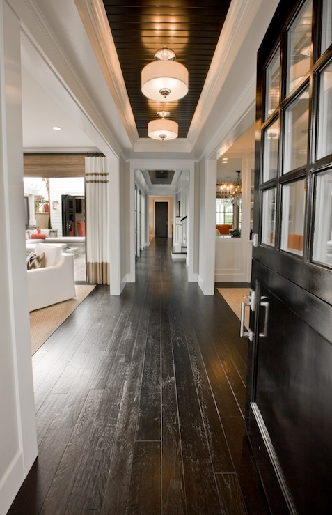 Gorgeous hall entry design with coffee stained hand scraped wood floors, glossy