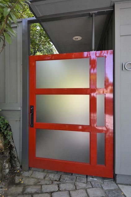 This modern reinterpretation of the red front door makes an immediate statement.