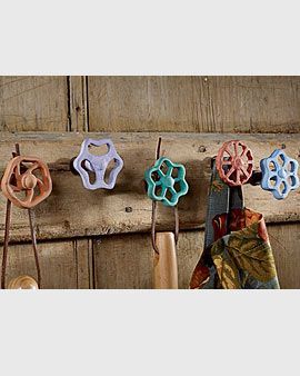 Vintage faucets, brightly painted and used as wall hooks to hang your garden too
