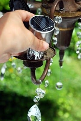 19. Replace the light bulbs in an old chandelier with inexpensive solar lights. Hang it from a tree branch. -   32 Cheap And Easy Backyard Ideas