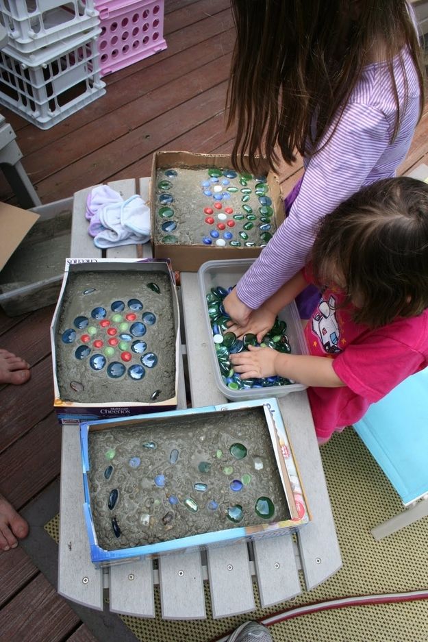 23. Enlist the kids to help you make stepping stones out of cement, cereal boxes, and glass stones. -   32 Cheap And Easy Backyard Ideas