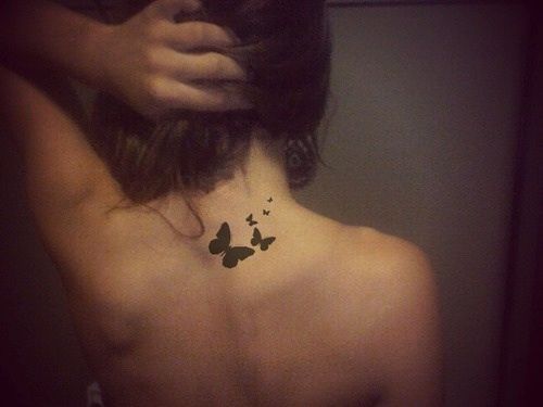 Small butterfly tattoo on the back of the neck.
