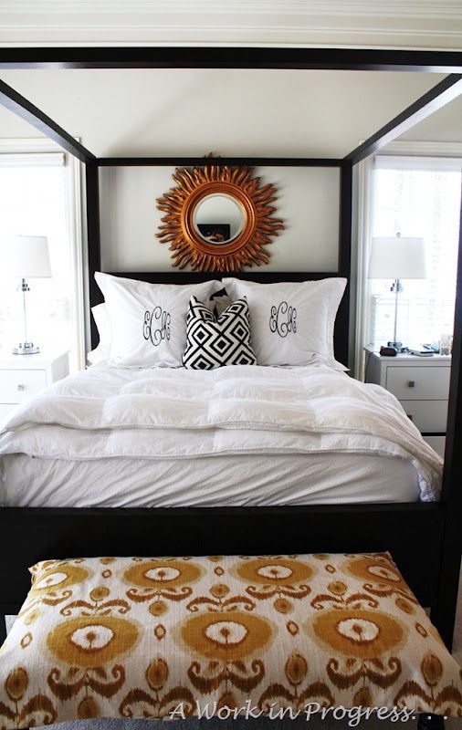 large sunburst mirror, ikat +david hicks, white bedding,  monogrammed shams