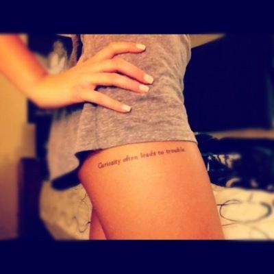 I usually don't like thigh tattoos, but this is cute. It says "Curiosity