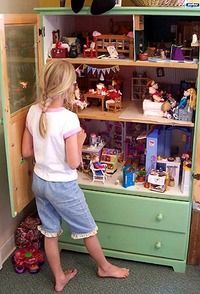 Turn a dresser or armoire into a gigantic doll house and use drawers to store cl