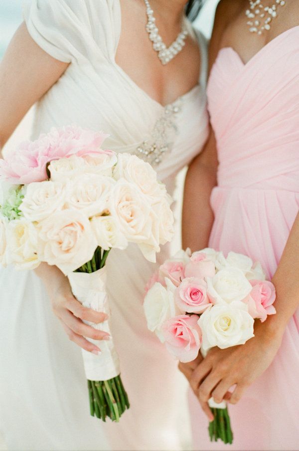 gorgeous pink and white flowers and dresses at a beach wedding