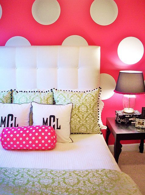fun girls bedroom with a bold hot pink and white polka dot wall.