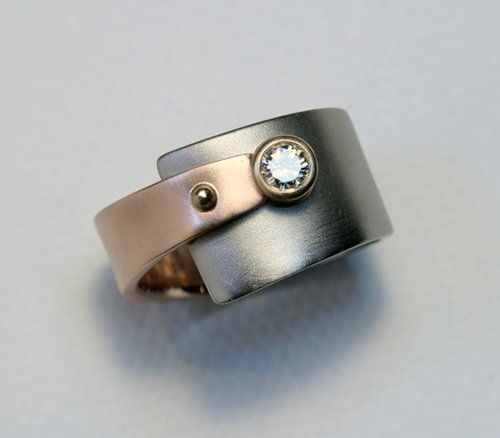 white and rose gold wedding rings by Cooperman Jewelry    I wouldnt wear this as