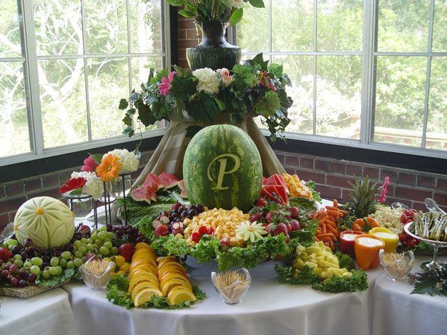 Fruit display with simple carved honeydew and watermelon, bell pepper dip contai