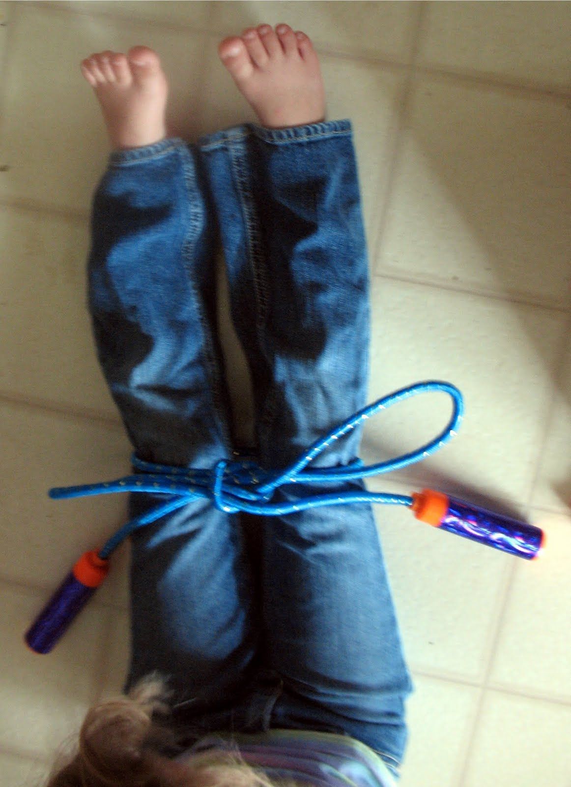 Smart! Teach a child to tie their shoes using a jump rope so they can see a larg