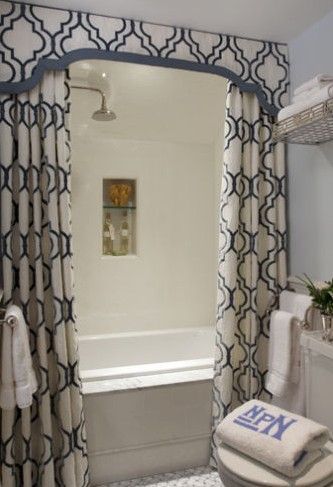 two shower curtains and a valence makes a boring bathtub look elegant