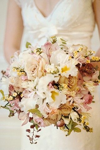 Wired bouquet of cattleya and cymbidium orchids, Quicksilver roses, ranunculus,
