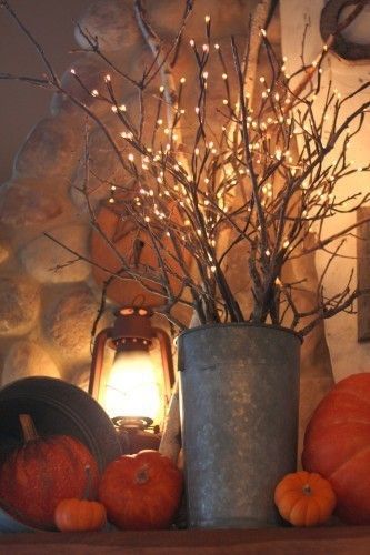 Love the ambience of lantern light in fall arrangements this year!
