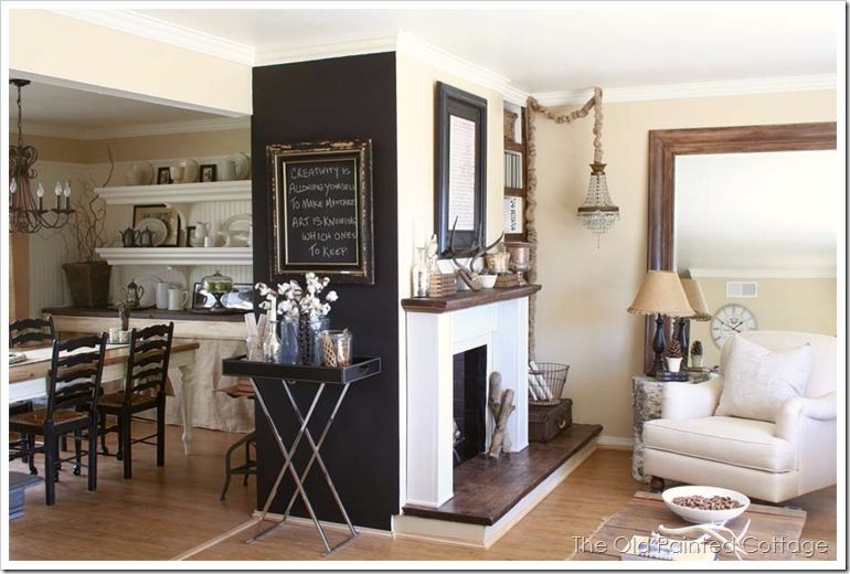 Rustic dining room, half open to the living room, black accent wall goes well wi