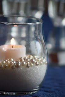Sand, Epsom salt or sugar, faux pearls & a candle. This is insanely easy and loo