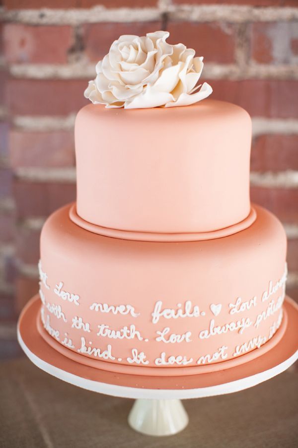 Soft coral wedding cake with an e.e. cummings poem