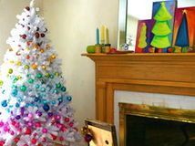 love this white tree with the colored ornaments done  in sections!