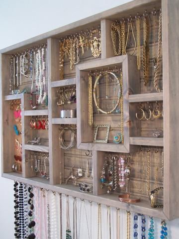 Get a collage picture frame, remove glass, insert screw in hooks to hang jewelry