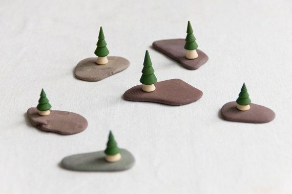 small sculptures, pebble and wooden christmas trees
