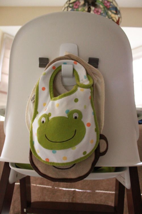 Use a command hook to hang bibs behind highchair…smart!