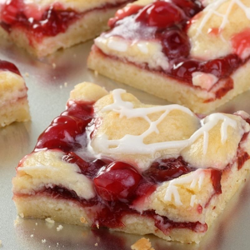 A Sweet and delicious recipe for cherry bars topped with yummy icing.
