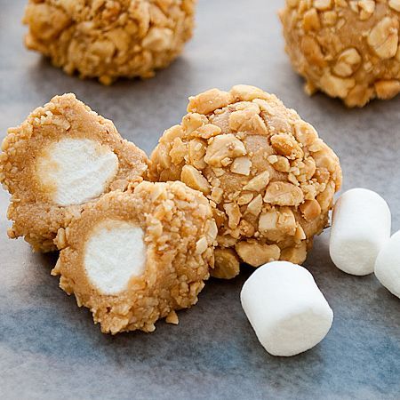 Marshmallows dipped in caramel, rolled in rice crispies. This recipe shows nuts,