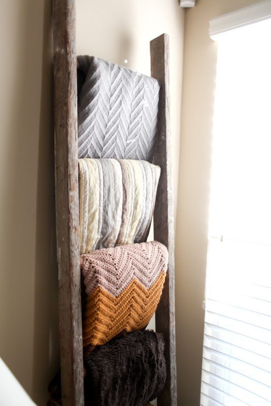 Great Idea: use an old ladder to hold blankets, for the bedroom.