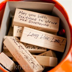 guests sign Jenga blocks so that when the couple plays the game in the future, t